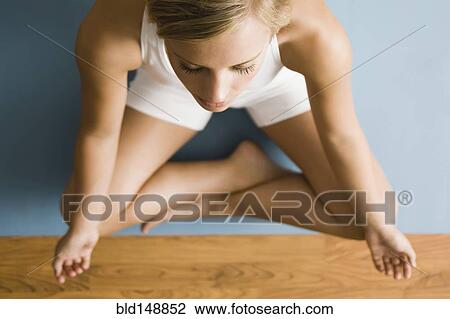 Stock Image - Caucasian woman practicing yoga. Fotosearch