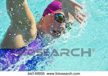 Stock Photography - Caucasian woman swimming. Fotosearch