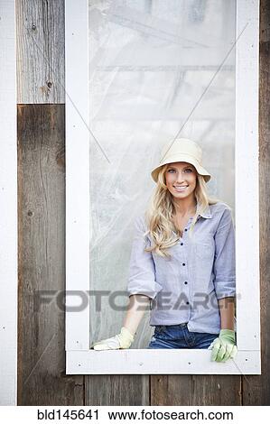 Caucasian woman wearing gloves standing in window View Large Photo Image Stock Image - Caucasian woman wearing gloves standing in window. Fotosearch