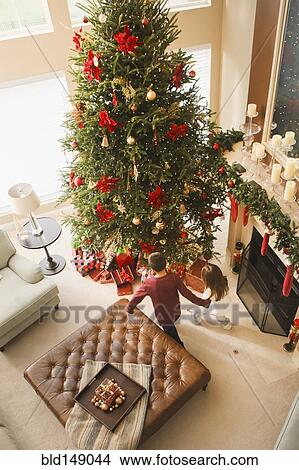 Picture - Children opening gifts Christmas morning. Fotosearch