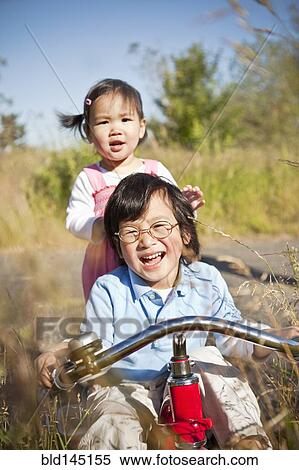 Chinese brother and sister riding tricycle View Large Photo Image Stock Photography - Chinese brother and sister riding tricycle. Fotosearch