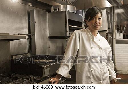 Chinese chef standing in commercial kitchen View Large Photo Image Stock Photo - Chinese chef standing in commercial kitchen. Fotosearch