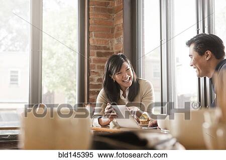 Chinese woman digital tablet to husband in cafe View Large Photo Image Stock Photography - Chinese woman digital tablet to husband in cafe. Fotosearch
