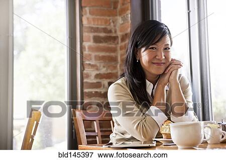Chinese woman drinking coffee in cafe View Large Photo Image Stock Photo - Chinese woman drinking coffee in cafe. Fotosearch