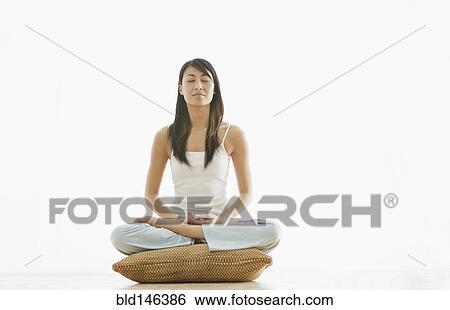 Stock Photograph - Chinese woman practicing yoga. Fotosearch