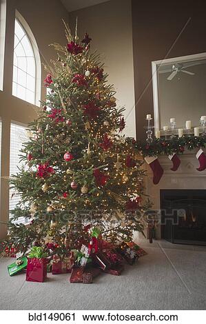 Stock Image - Christmas tree and decorations in living room. Fotosearch