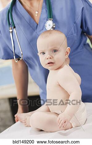 Doctor and baby in doctor's office View Large Photo Image Stock Image - Doctor and baby in doctor's office. Fotosearch