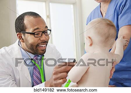 Doctor and nurse examining baby in doctor's office View Large Photo Image Stock Image - Doctor and nurse examining baby in doctor's office. Fotosearch