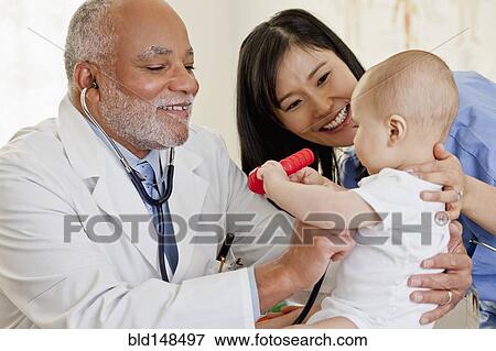 Doctor examining baby boy View Large Photo Image Stock Photo - Doctor examining baby boy. Fotosearch