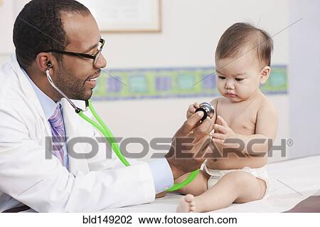 Doctor examining baby in doctor's office View Large Photo Image Stock Image - Doctor examining baby in doctor's office. Fotosearch