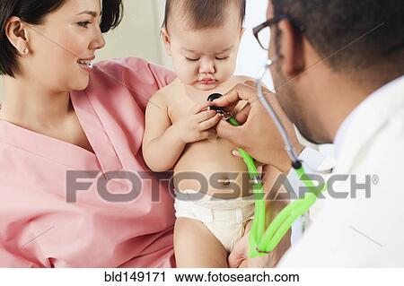 Doctor listening to baby's breathing in doctor's office View Large Photo Image Stock Image - Doctor listening to baby's breathing in doctor's office. Fotosearch