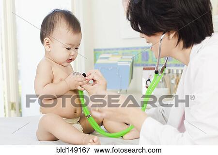 Doctor listening to baby's breathing in doctor's office View Large Photo Image Stock Photo - Doctor listening to baby's breathing in doctor's office. Fotosearch