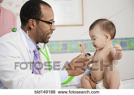 Stock Photo - Doctor using stethoscope on baby in doctor's office. Fotosearch