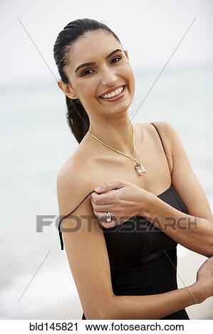 Elegant Brazilian woman lifting dress strap View Large Photo Image Stock Image - Elegant Brazilian woman lifting dress strap. Fotosearch