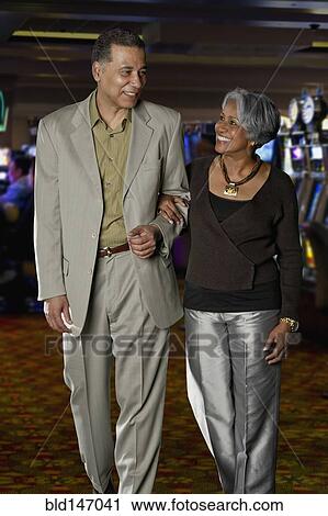 Excited Black couple walking in casino View Large Photo Image Stock Image - Excited Black couple walking in casino. Fotosearch