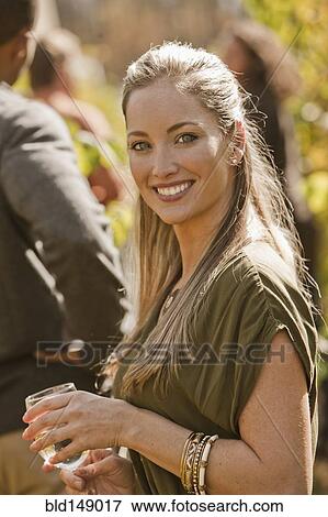 Stock Photo - Friends drinking wine in vineyard. Fotosearch