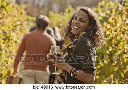 Friends drinking wine in vineyard View Large Photo Image Stock Photograph - Friends drinking wine in vineyard. Fotosearch