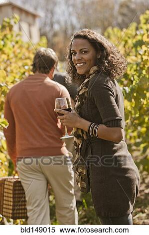 Friends drinking wine in vineyard View Large Photo Image Stock Photography - Friends drinking wine in vineyard. Fotosearch