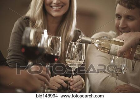 Picture - Friends drinking wine together. Fotosearch