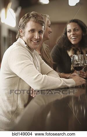 Friends drinking wine together View Large Photo Image Picture - Friends drinking wine together. Fotosearch