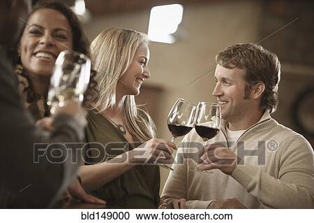 Friends drinking wine together View Large Photo Image Stock Image - Friends drinking wine together. Fotosearch