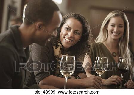 Friends drinking wine together View Large Photo Image Stock Photo - Friends drinking wine together. Fotosearch