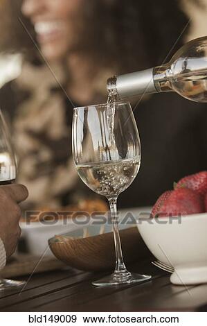 Stock Photo - Friends drinking wine together. Fotosearch