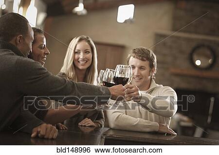 Stock Photograph - Friends drinking wine together. Fotosearch
