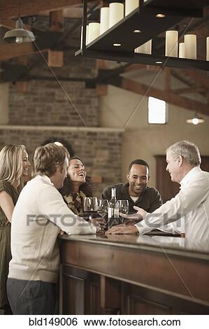 Friends drinking wine together View Large Photo Image Stock Photograph - Friends drinking wine together. Fotosearch