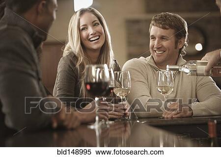 Stock Photography - Friends drinking wine together. Fotosearch