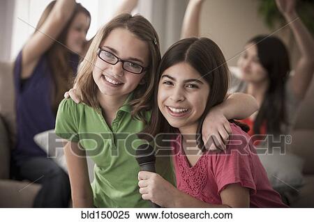 Friends singing karaoke together View Large Photo Image Stock Photography - Friends singing karaoke together. Fotosearch