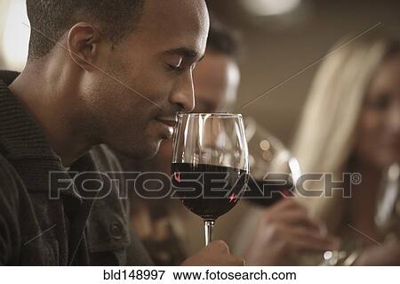 Stock Photo - Friends tasting wine together. Fotosearch
