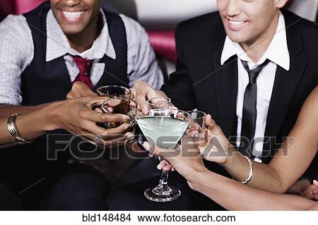 Friends toasting in nightclub View Large Photo Image Picture - Friends toasting in nightclub. Fotosearch