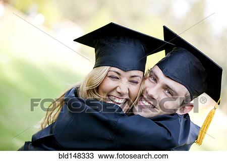 Graduating Hispanic couple in cap and gown hugging View Large Photo Image Stock Image - Graduating Hispanic couple in cap and gown hugging. Fotosearch