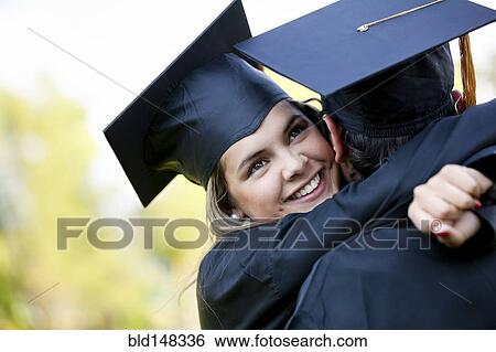 Graduating Hispanic couple in cap and gown hugging View Large Photo Image Stock Photograph - Graduating Hispanic couple in cap and gown hugging. Fotosearch