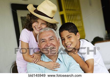Stock Photo - Grandchildren hugging grandfather. Fotosearch