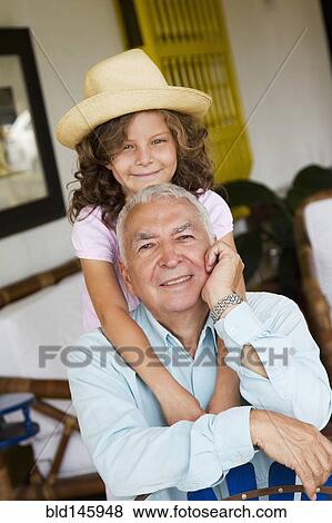 Granddaughter hugging grandfather View Large Photo Image Stock Photo - Granddaughter hugging grandfather. Fotosearch