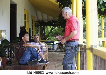 Grandfather, father and son talking on porch View Large Photo Image Stock Image - Grandfather, father and son talking on porch. Fotosearch