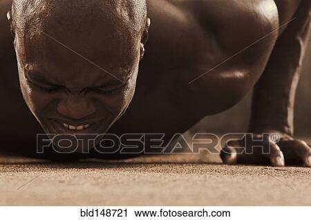 Grimacing African American man doing push-ups View Large Photo Image Stock Image - Grimacing African American man doing push-ups. Fotosearch