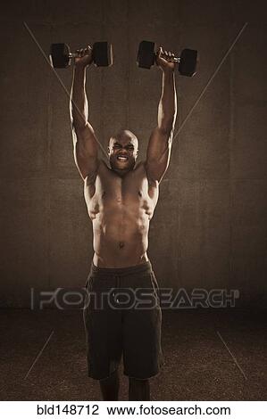 Grimacing African American man lifting weights View Large Photo Image Stock Image - Grimacing African American man lifting weights. Fotosearch
