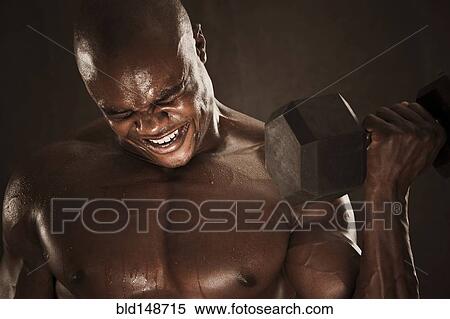 Grimacing African American man lifting weights View Large Photo Image Stock Photography - Grimacing African American man lifting weights. Fotosearch
