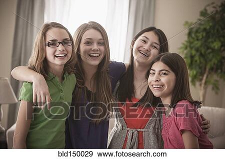 Grinning friends hugging View Large Photo Image Stock Photo - Grinning friends hugging. Fotosearch