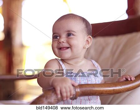 Hispanic baby girl sitting in chair View Large Photo Image Stock Photo - Hispanic baby girl sitting in chair. Fotosearch