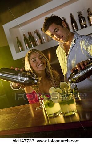 Hispanic bartenders preparing cocktails in bar View Large Photo Image Stock Image - Hispanic bartenders preparing cocktails in bar. Fotosearch