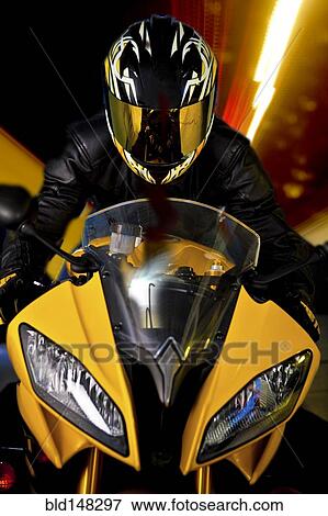 Hispanic biker in reflective helmet riding motorcycle View Large Photo Image Stock Photo - Hispanic biker in reflective helmet riding motorcycle. Fotosearch