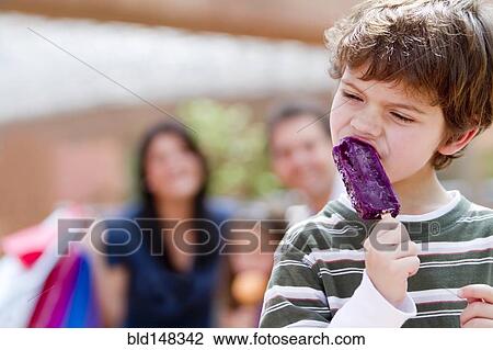 Hispanic boy eating popsicle View Large Photo Image Stock Image - Hispanic boy eating popsicle. Fotosearch
