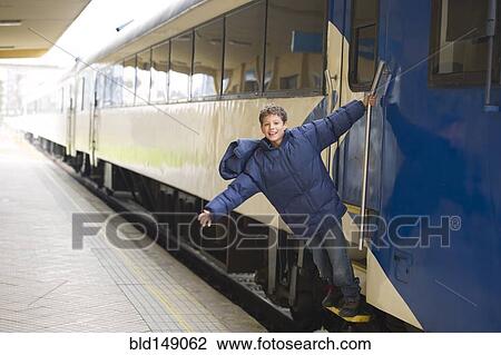 Hispanic boy standing on stairs of train View Large Photo Image Stock Image - Hispanic boy standing on stairs of train. Fotosearch