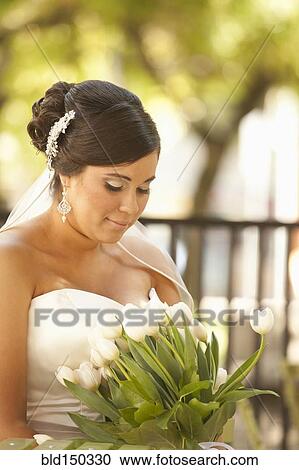 Hispanic bride holding bouquet View Large Photo Image Stock Image - Hispanic bride holding bouquet. Fotosearch