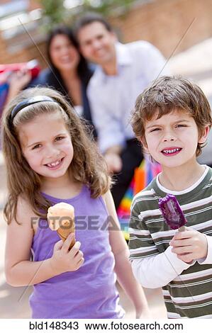 Hispanic brother and sister eating ice cream View Large Photo Image Stock Image - Hispanic brother and sister eating ice cream. Fotosearch