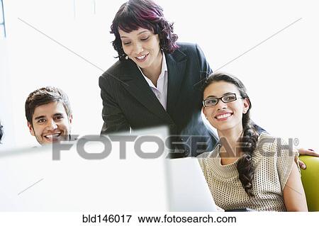 Hispanic business people working together in office View Large Photo Image Stock Photo - Hispanic business people working together in office. Fotosearch